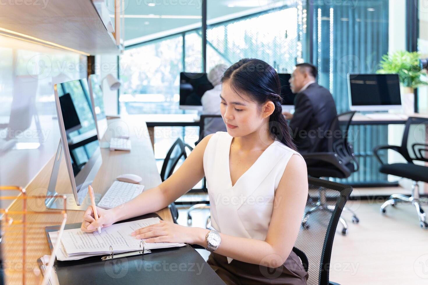 Asian businesswoman in formal suit working in modern luxury office using computer for business and education concept photo