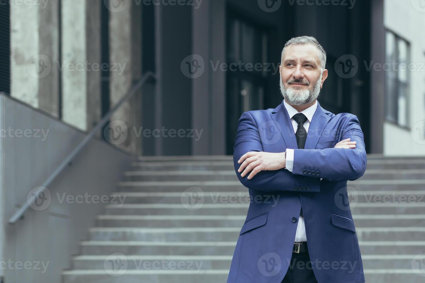 Portrait of successful director and business owner, man with crossed arms smiling outside office building, businessman investor in business suit confident photo