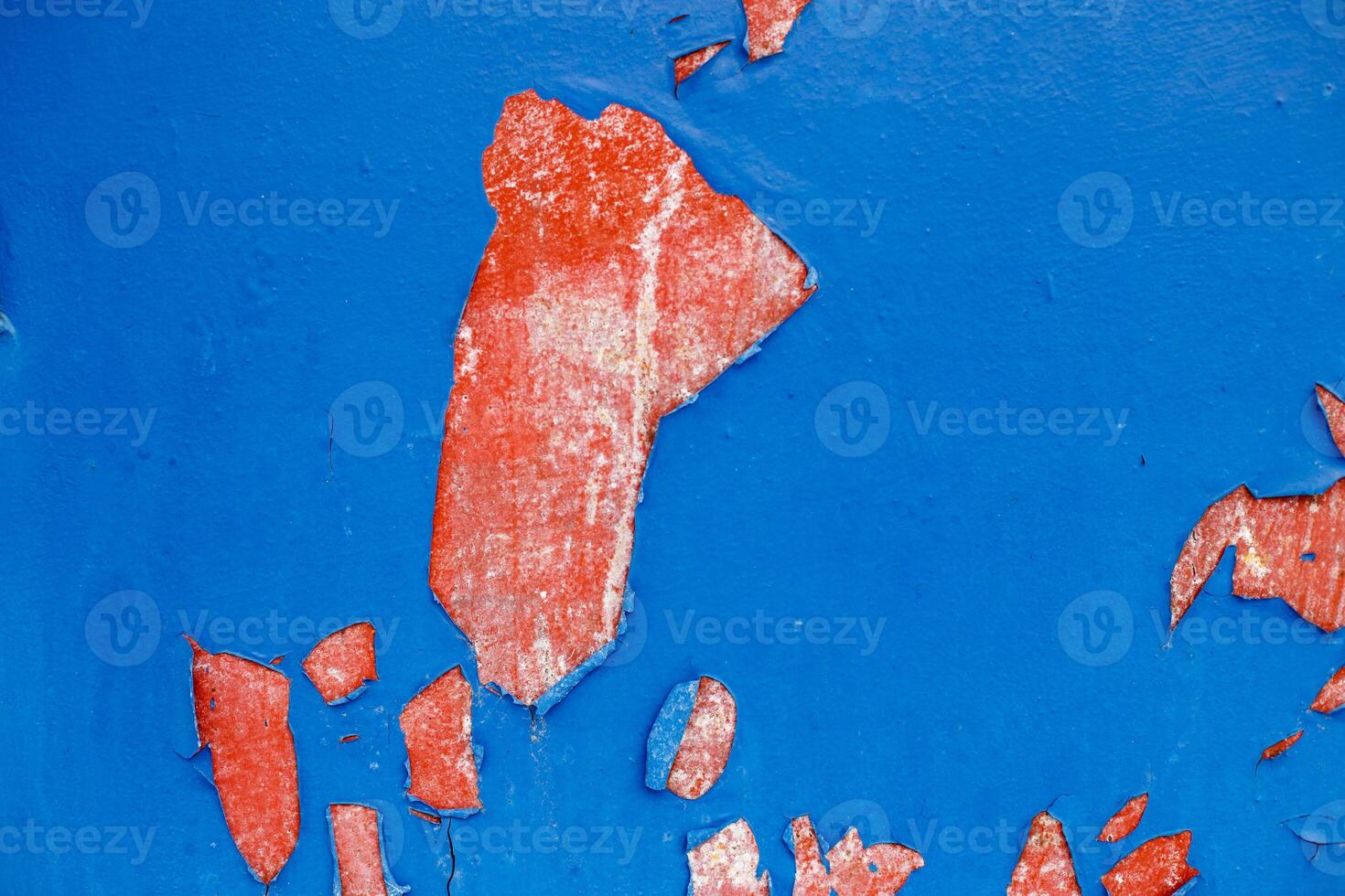 Old blue paint peeling from red concrete wall texture background. photo