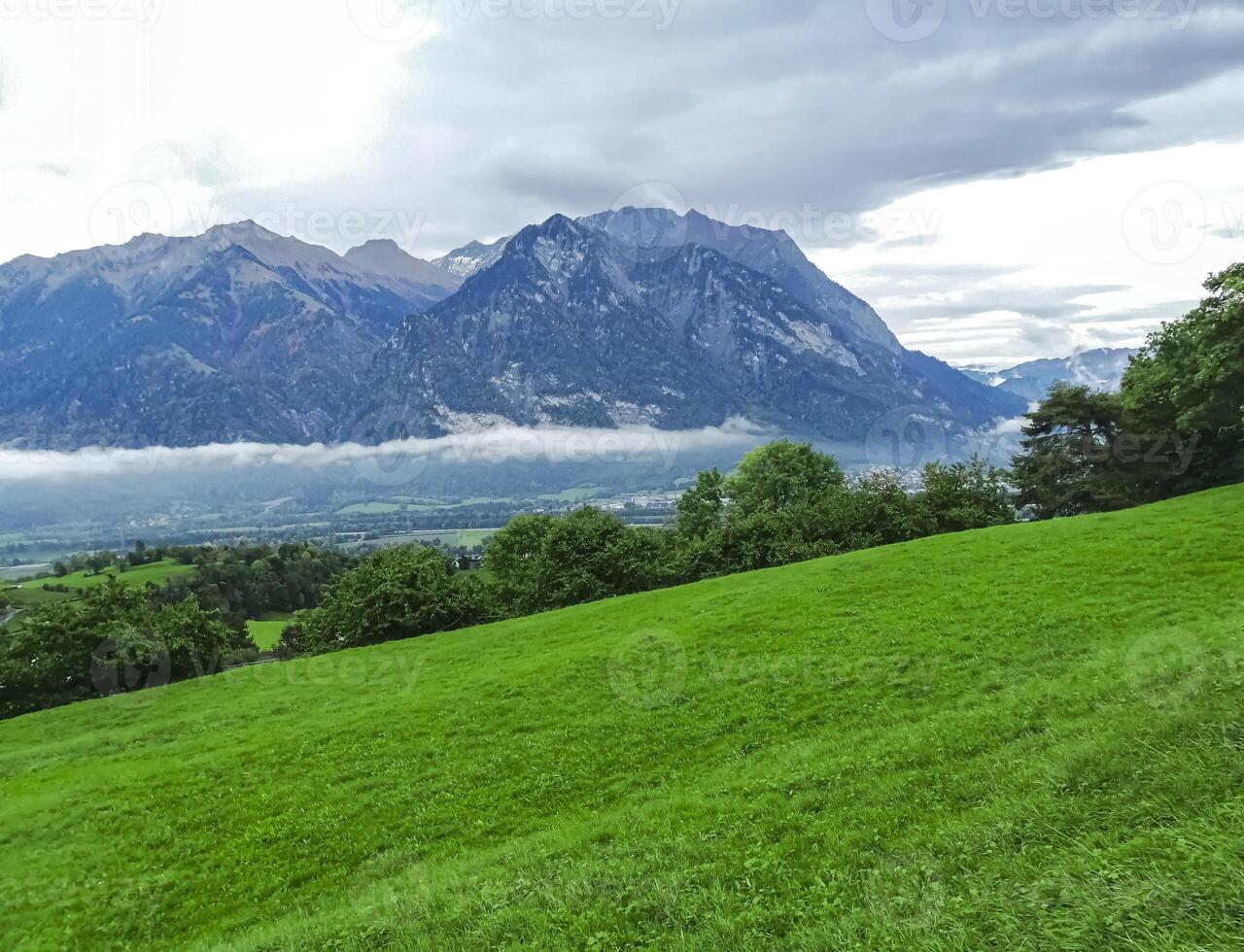 View from the mountain. Clouds, sky, green grass, mountains. Switzerland photo
