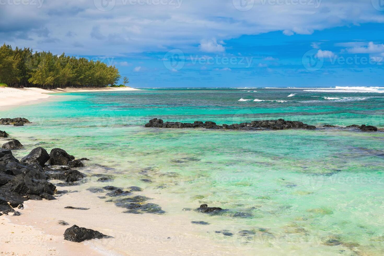 Tropical beach with sand, rocks, transparent ocean and blue sky in Mauritius photo