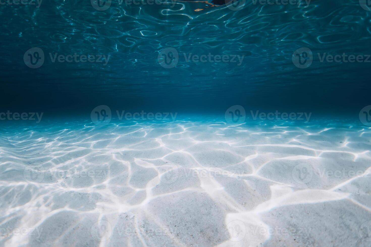 Tropical blue ocean with sandy bottom on Bahamas islands. Panoramic underwater background photo