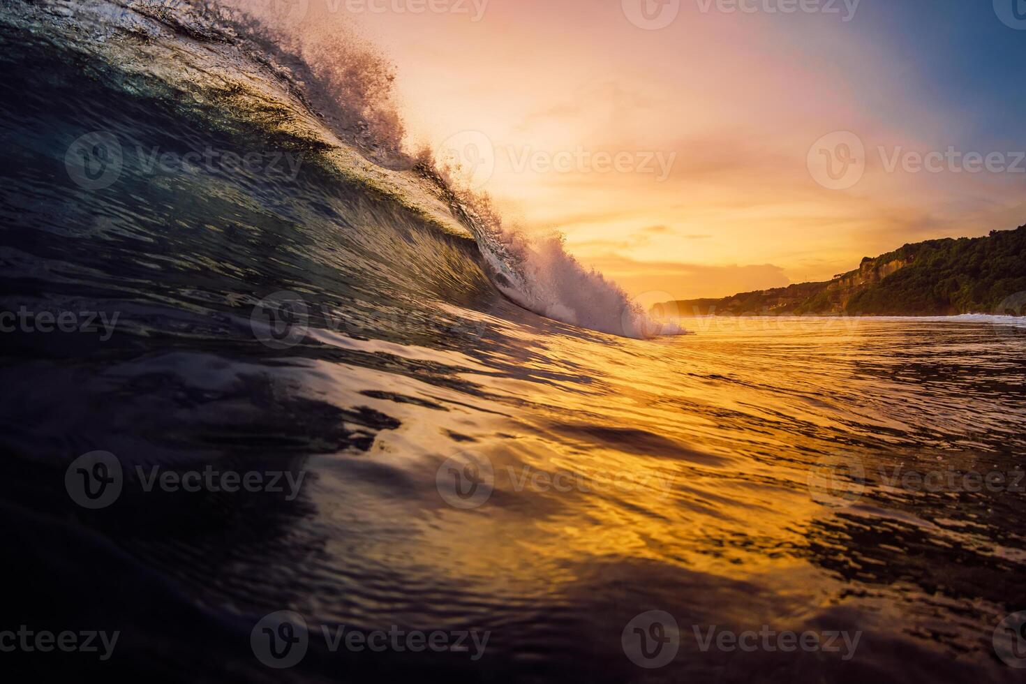 Perfect surfing wave with warm sunset tones in ocean. photo