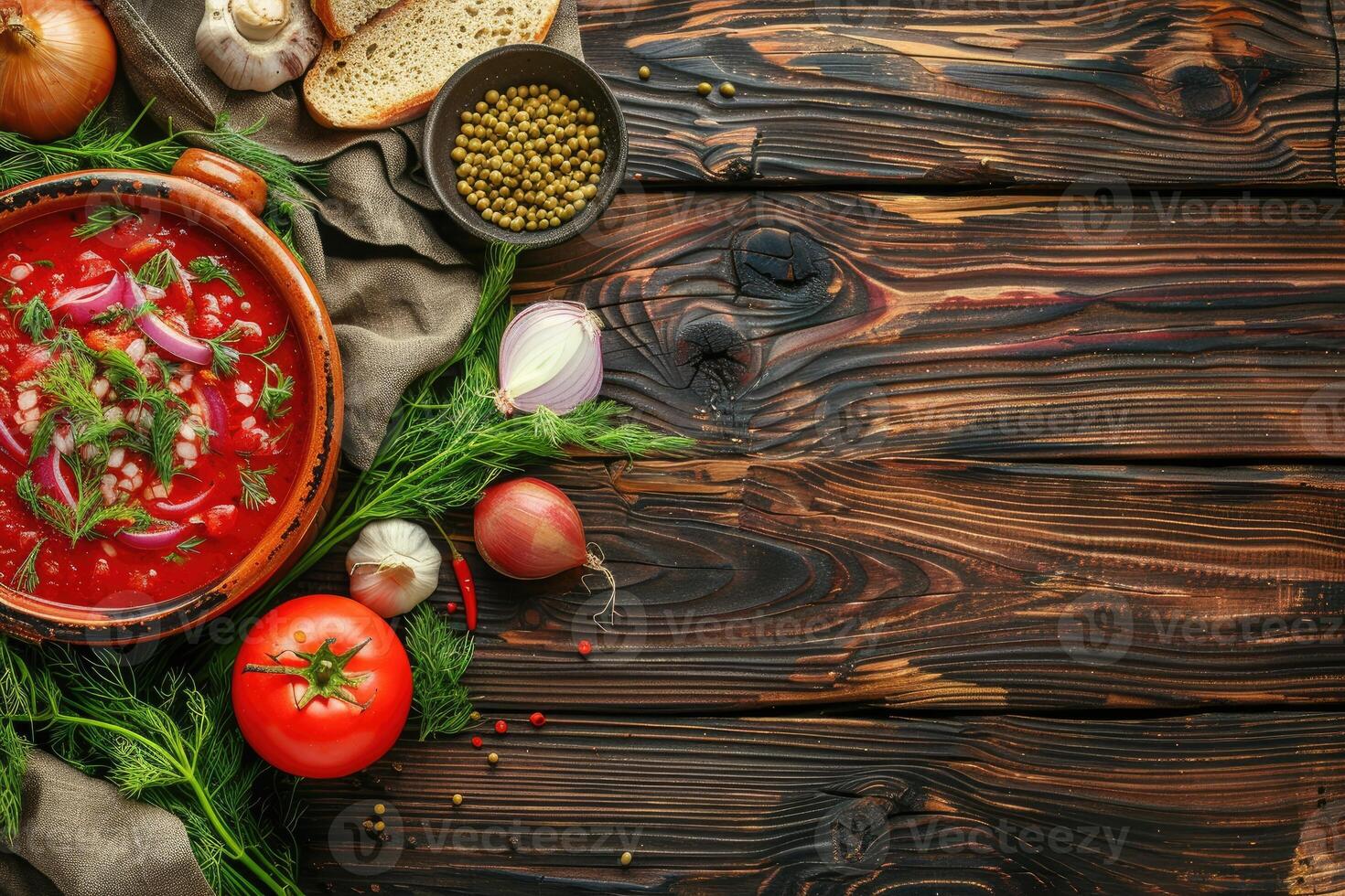 A plate of beet root soup borscht on a wooden table with vegetables, top view. Homemade food background with copy space photo