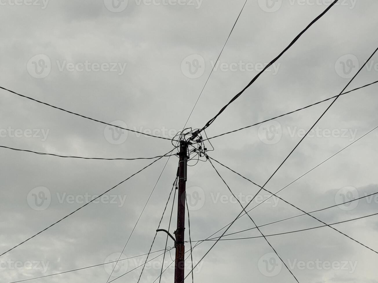 low angle view of electric cables against cloudy sky photo