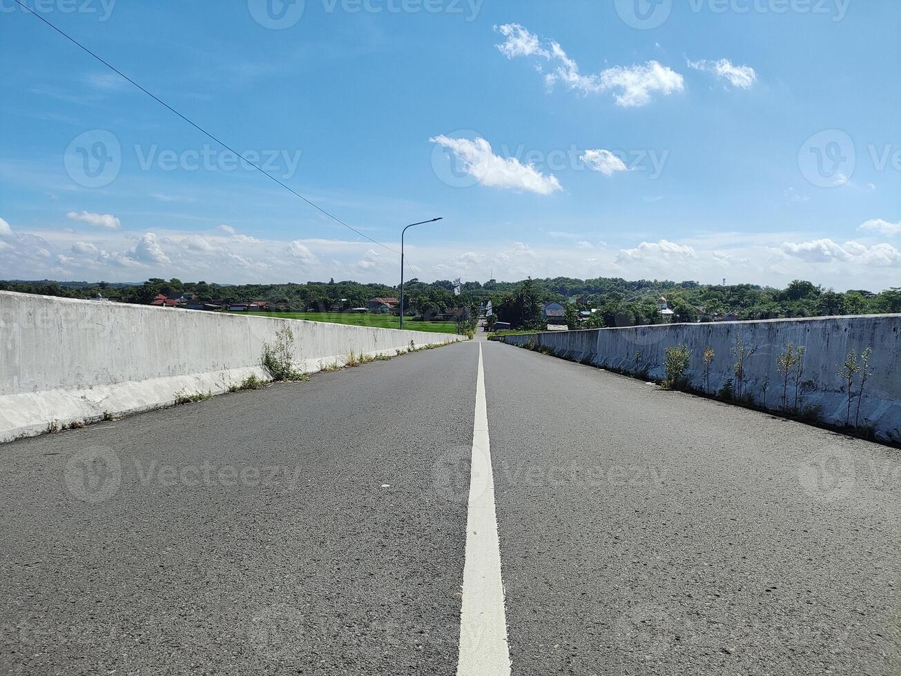 street view on flyover against blue sky photo