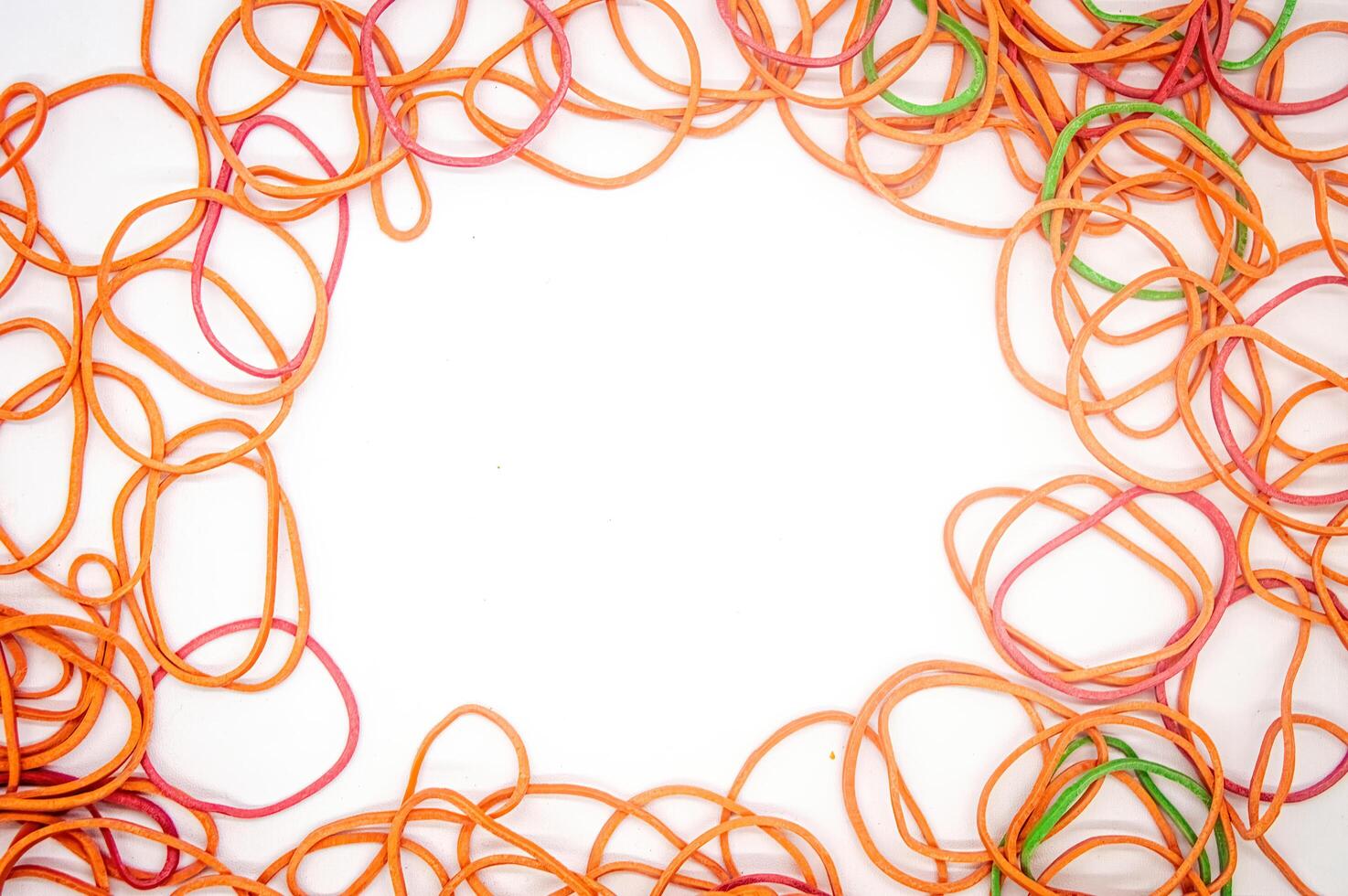a collection of rubber bands that form a frame with white copy space in the middle photo