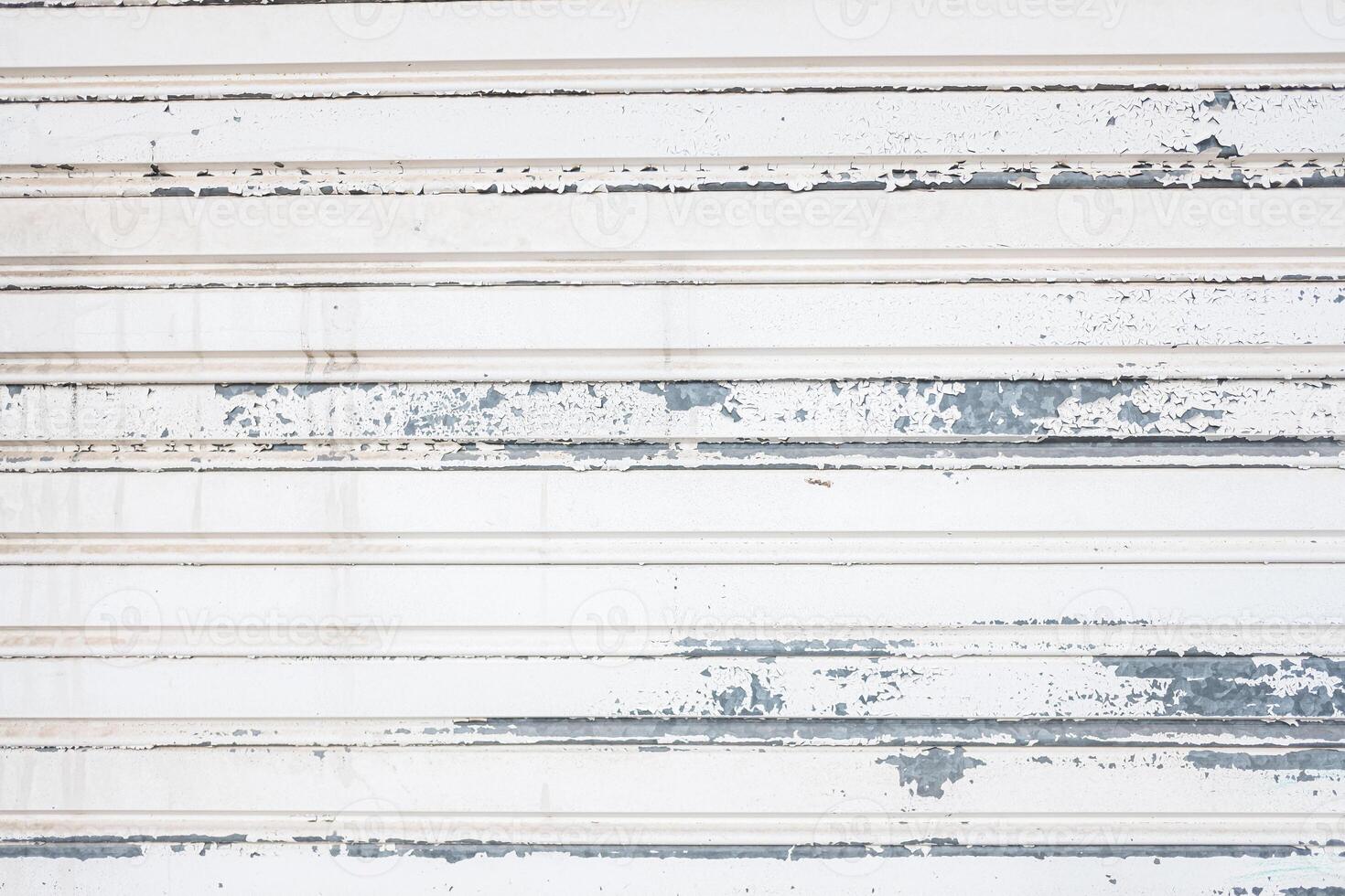 detail of the texture of a white painted metal shutter weathered, background photo