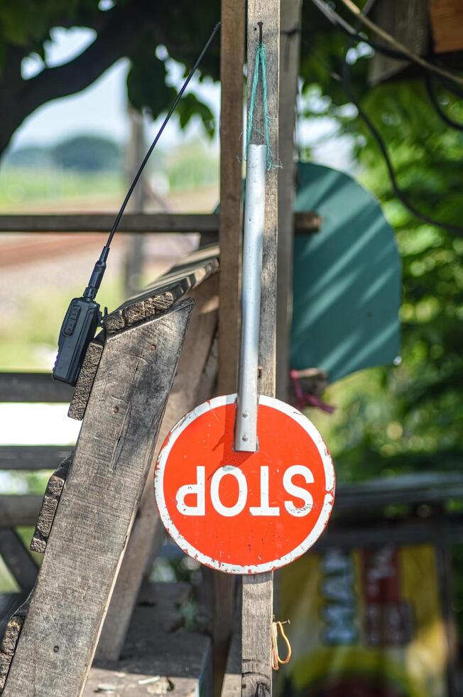 a stop sign that hangs on a railroad crossing photo