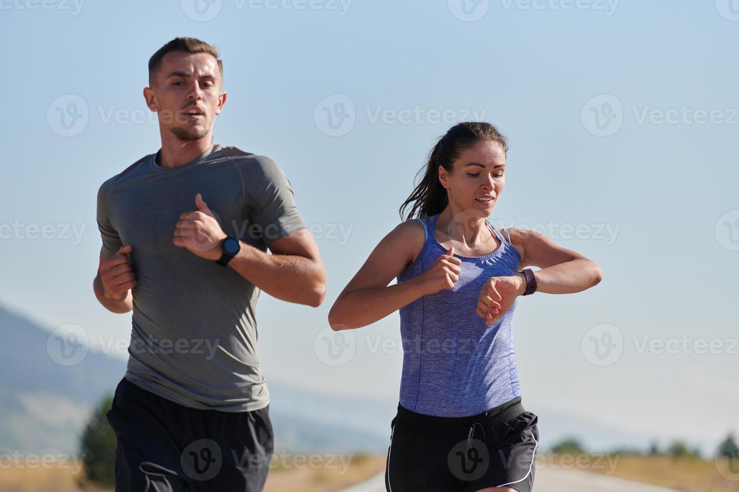 Energized by the beauty of nature, a couple powers through their morning run, their bodies and spirits invigorated. photo