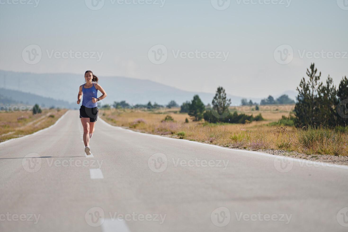 A determined woman athlete trains for success in the morning sun. photo