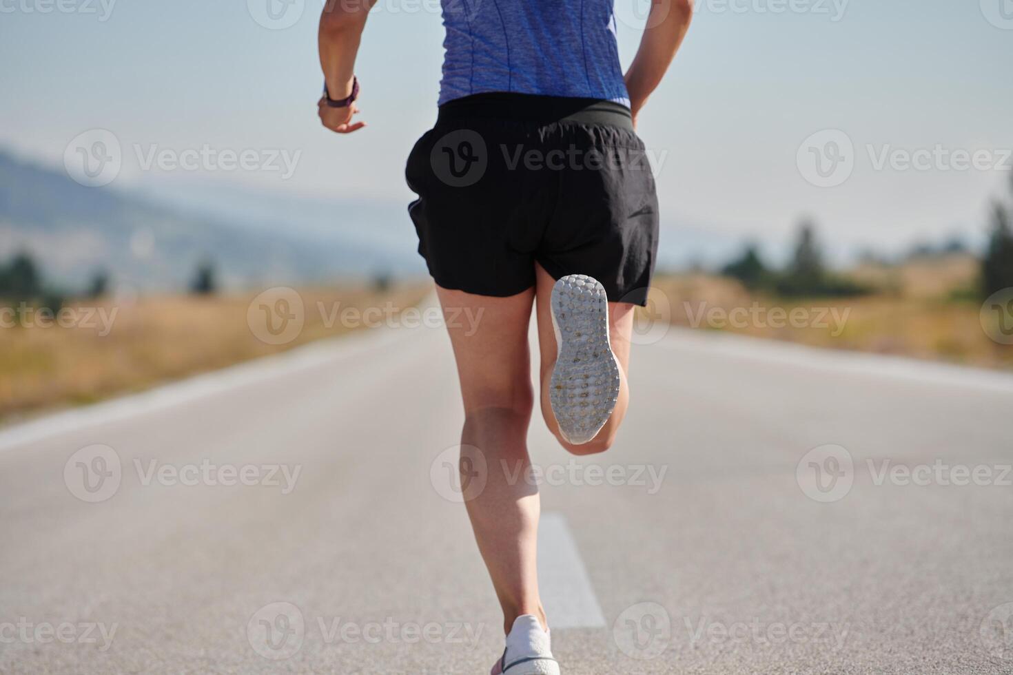 A determined woman athlete trains for success in the morning sun. photo