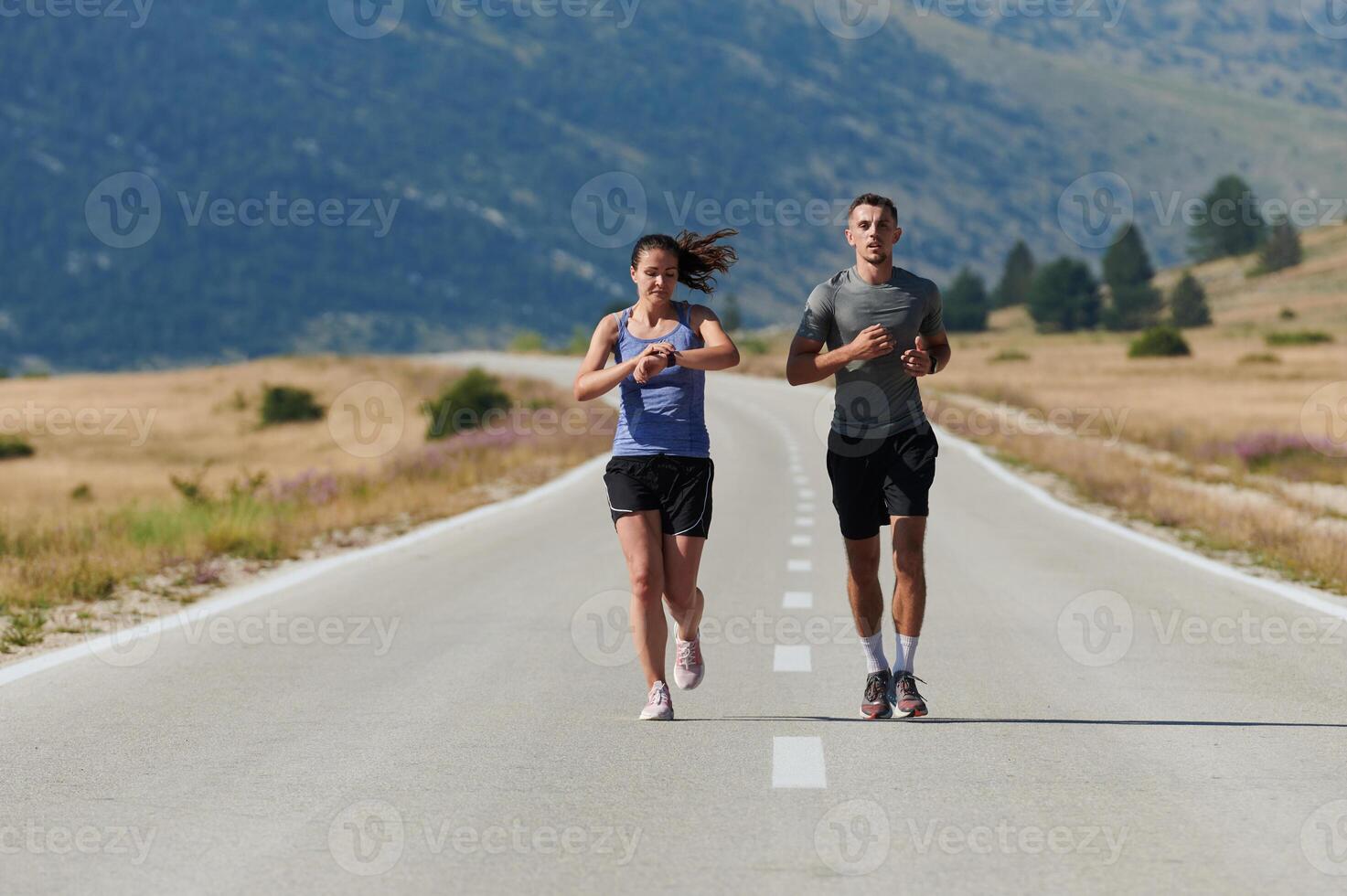 Energized by the beauty of nature, a couple powers through their morning run, their bodies and spirits invigorated. photo