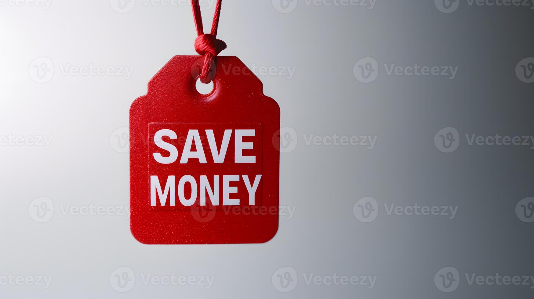 Red discount tag with 'Save Money' written on it. Saving money concept photo