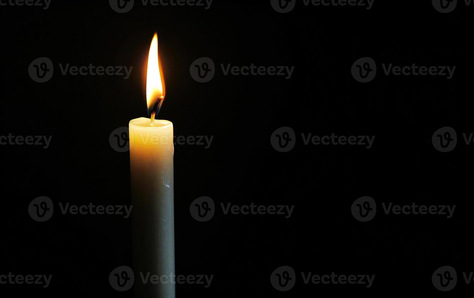 Burning white candle on black background. Close-up photo. With copy space. Image for memory of events and people photo