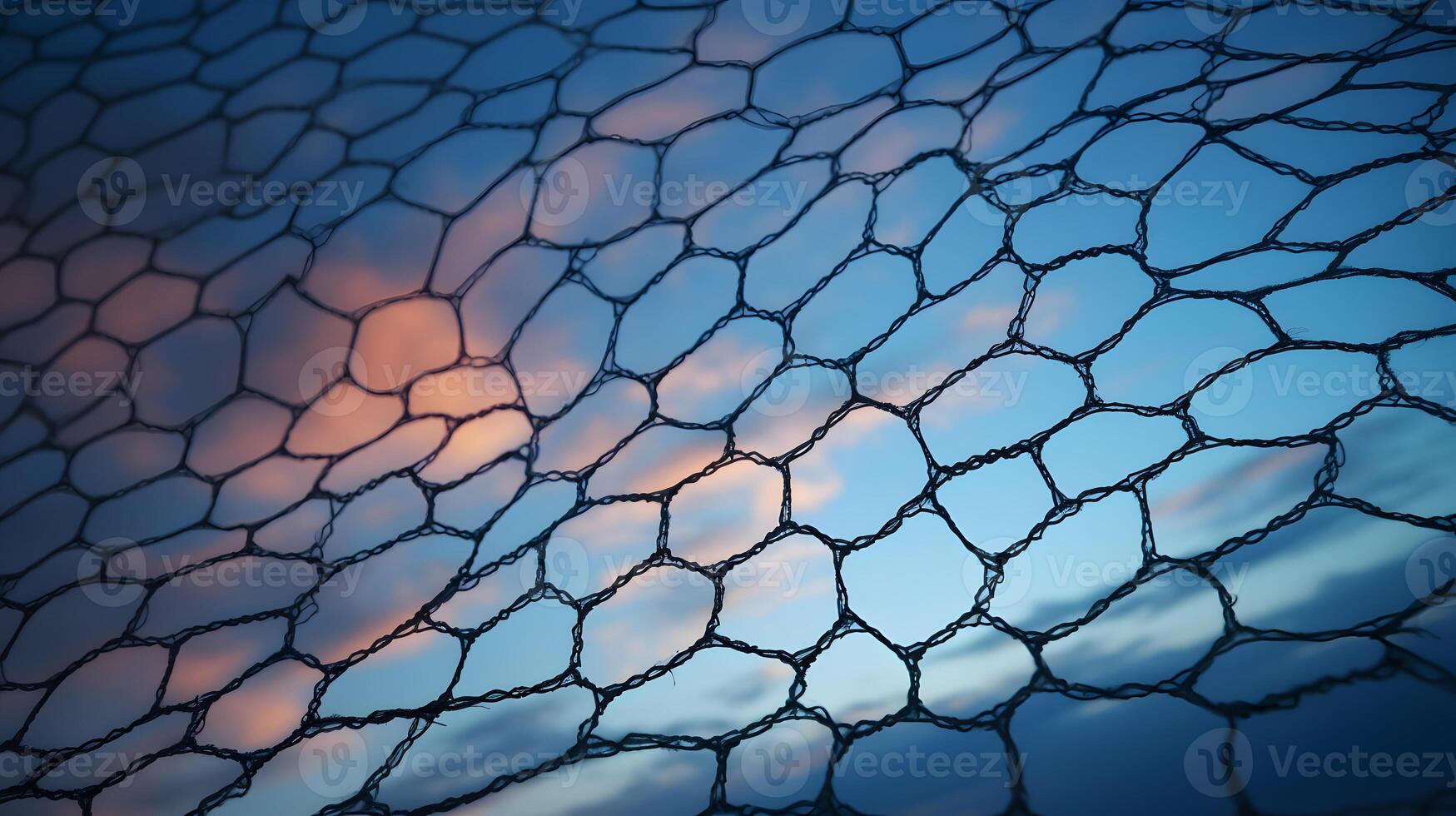 Old metal mesh against the background of sunset and clouds photo