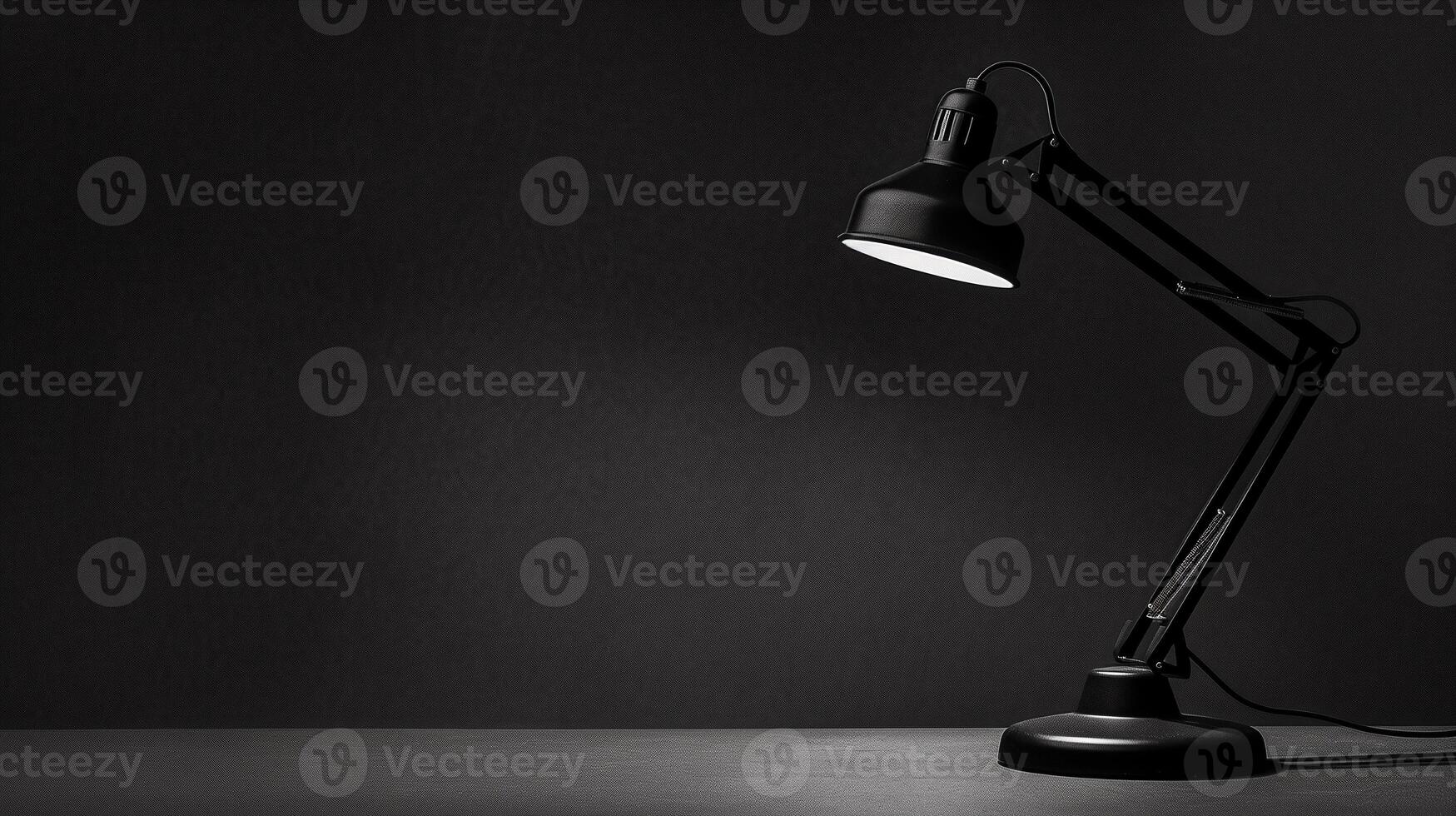 Modern and stylish desk lamp sits on the desk and illuminates minimalist empty workspace photo