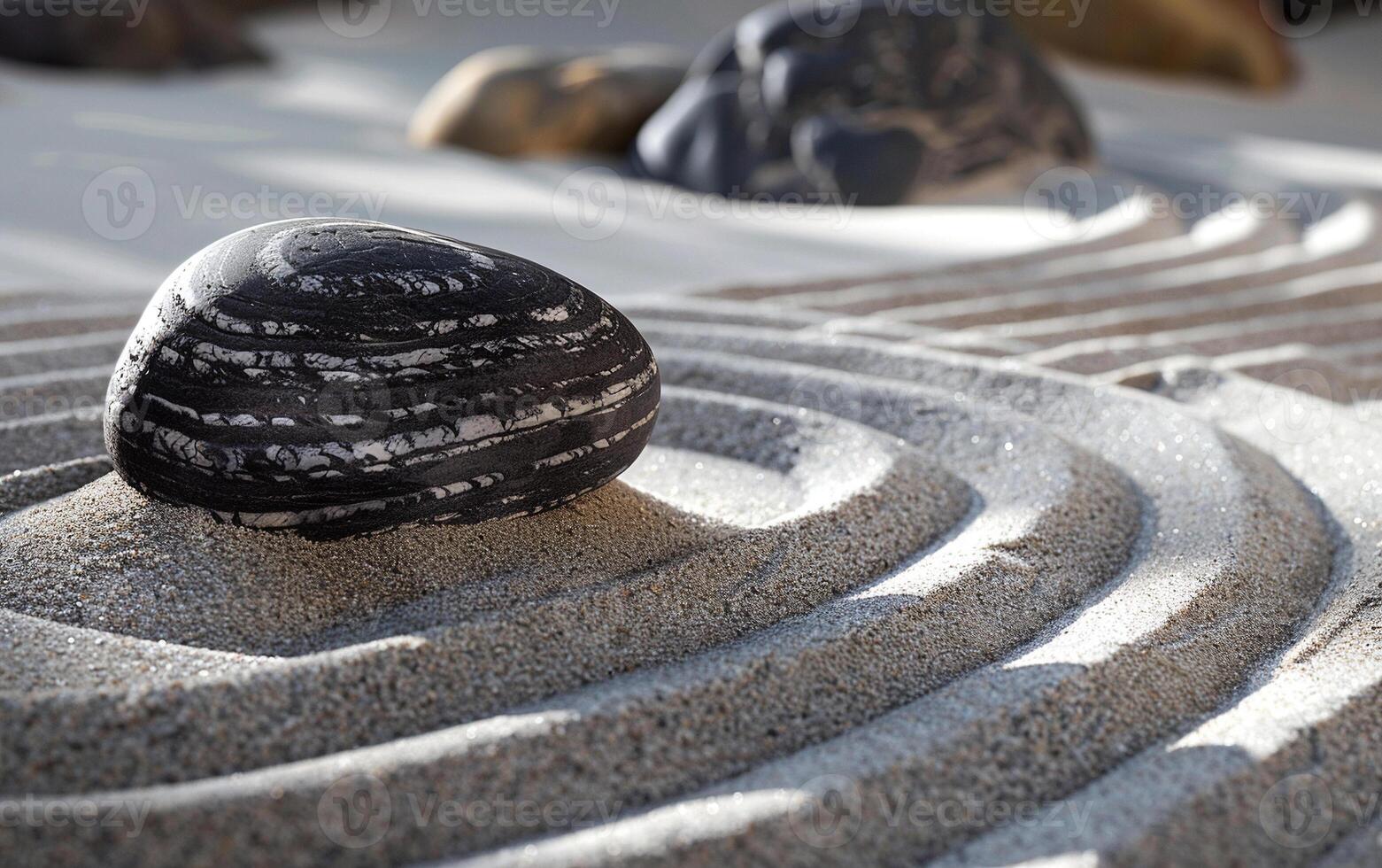 The atmosphere of meditation and tranquility is conveyed by the waves on the sand and zen stones. photo