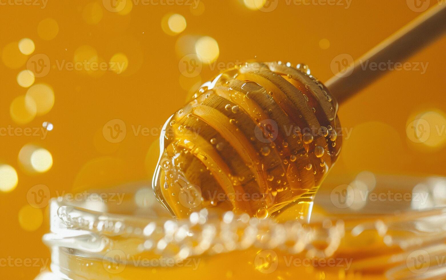 Honey flowing down spoon into honeycomb. Beautiful and presentational close-up photo
