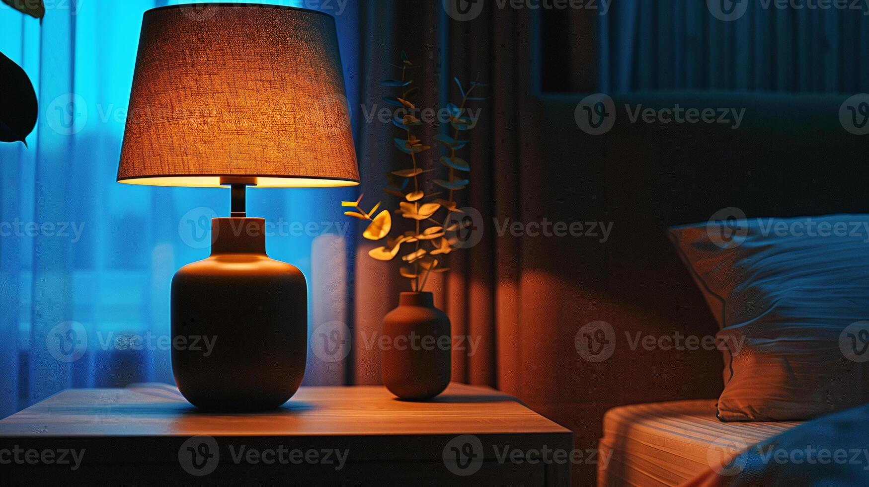 Cozy lamp standing on the bedside table creates a pleasant atmosphere in the room before bed. photo