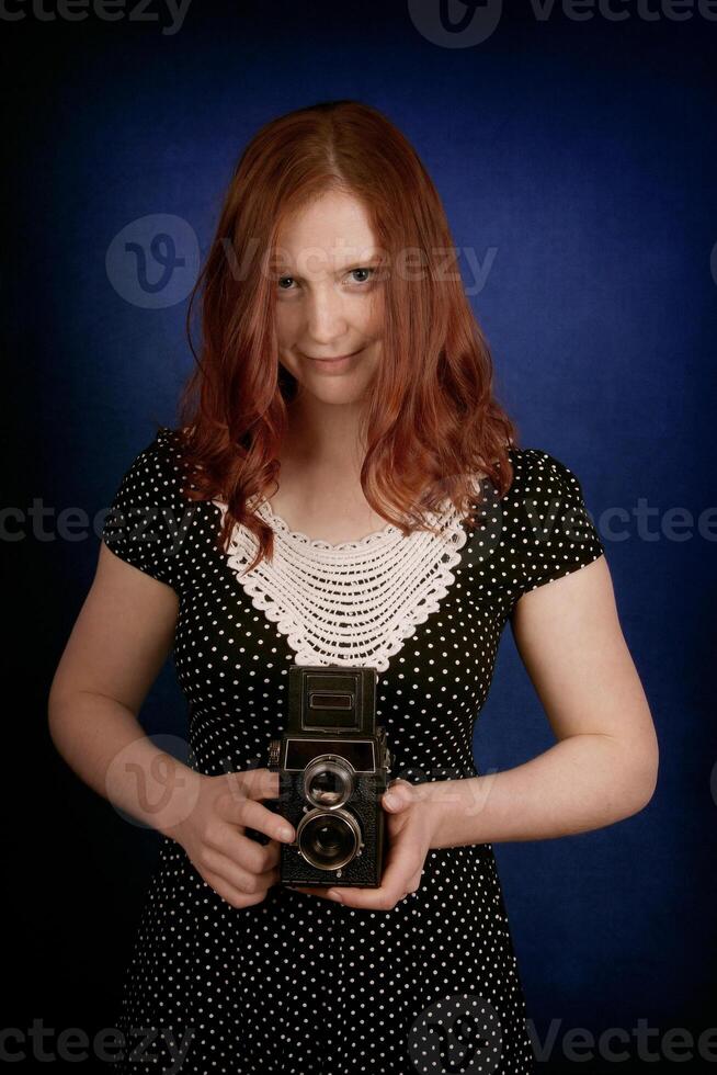 young woman with old camera photo