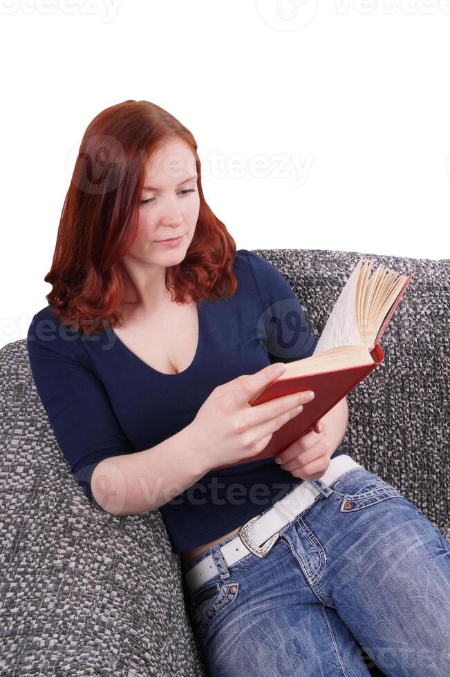 woman relaxing with book on couch photo