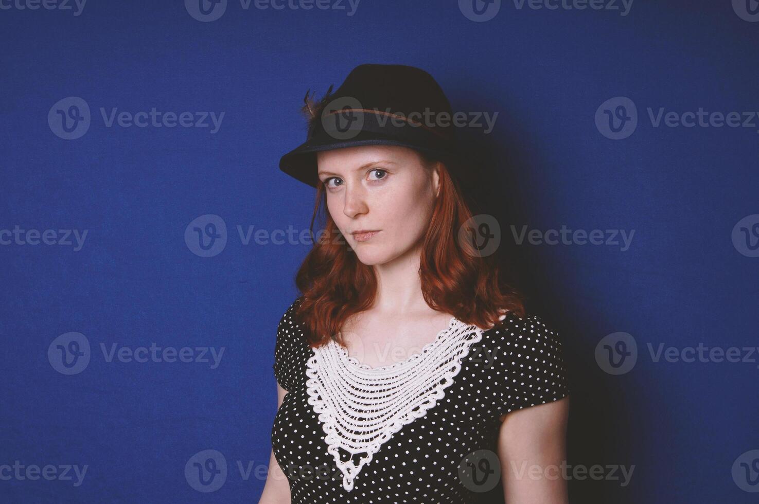 young woman wearing vintage dress and hat photo