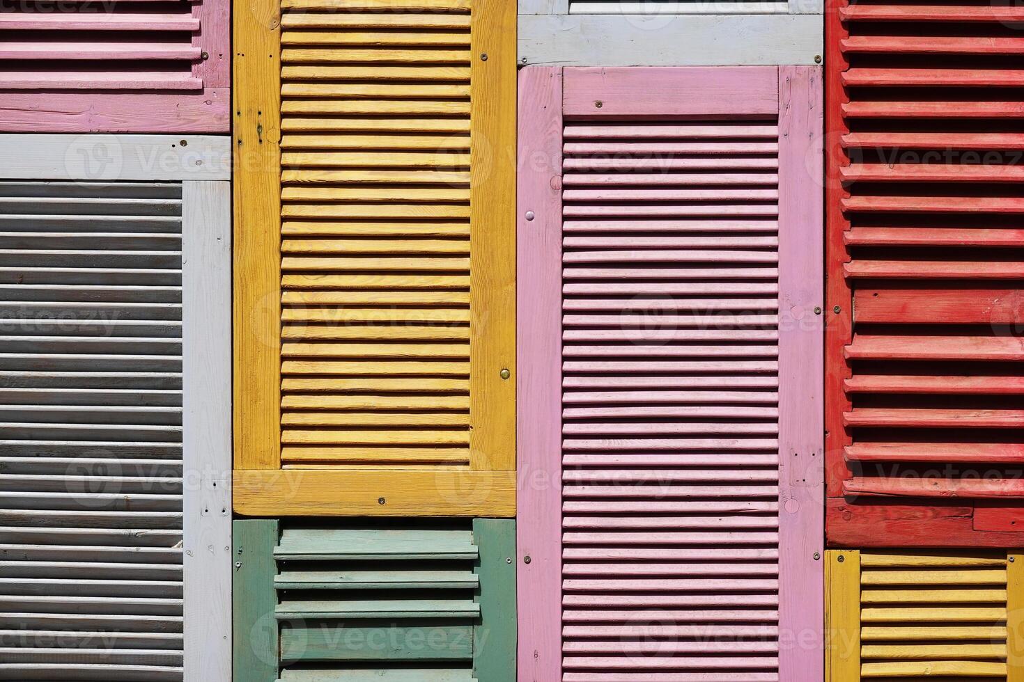 background made of multiple wooden shutters painted in bright colors photo