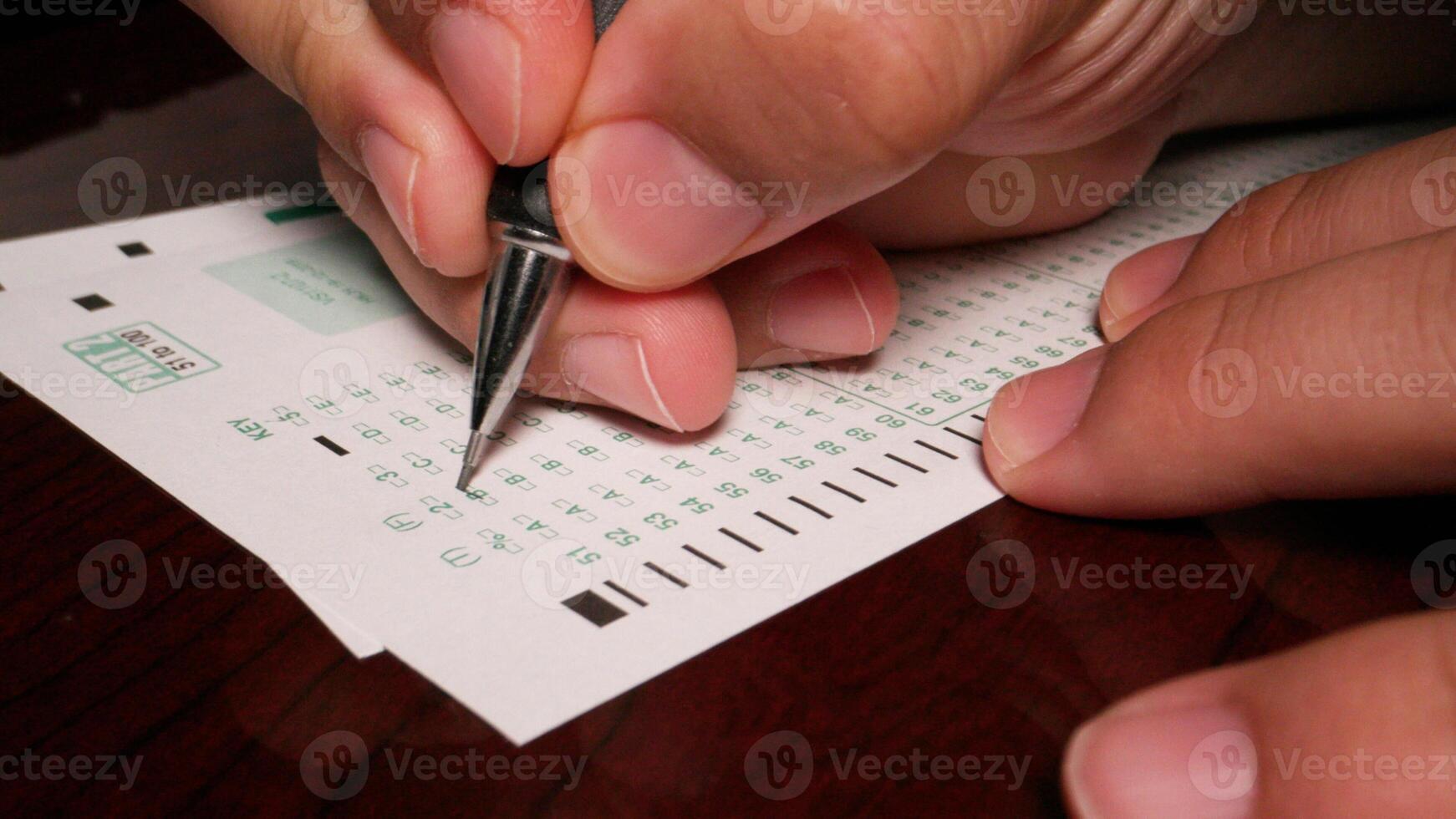 3 close up Hispanic male filling out multiple choice exam student testing paper photo