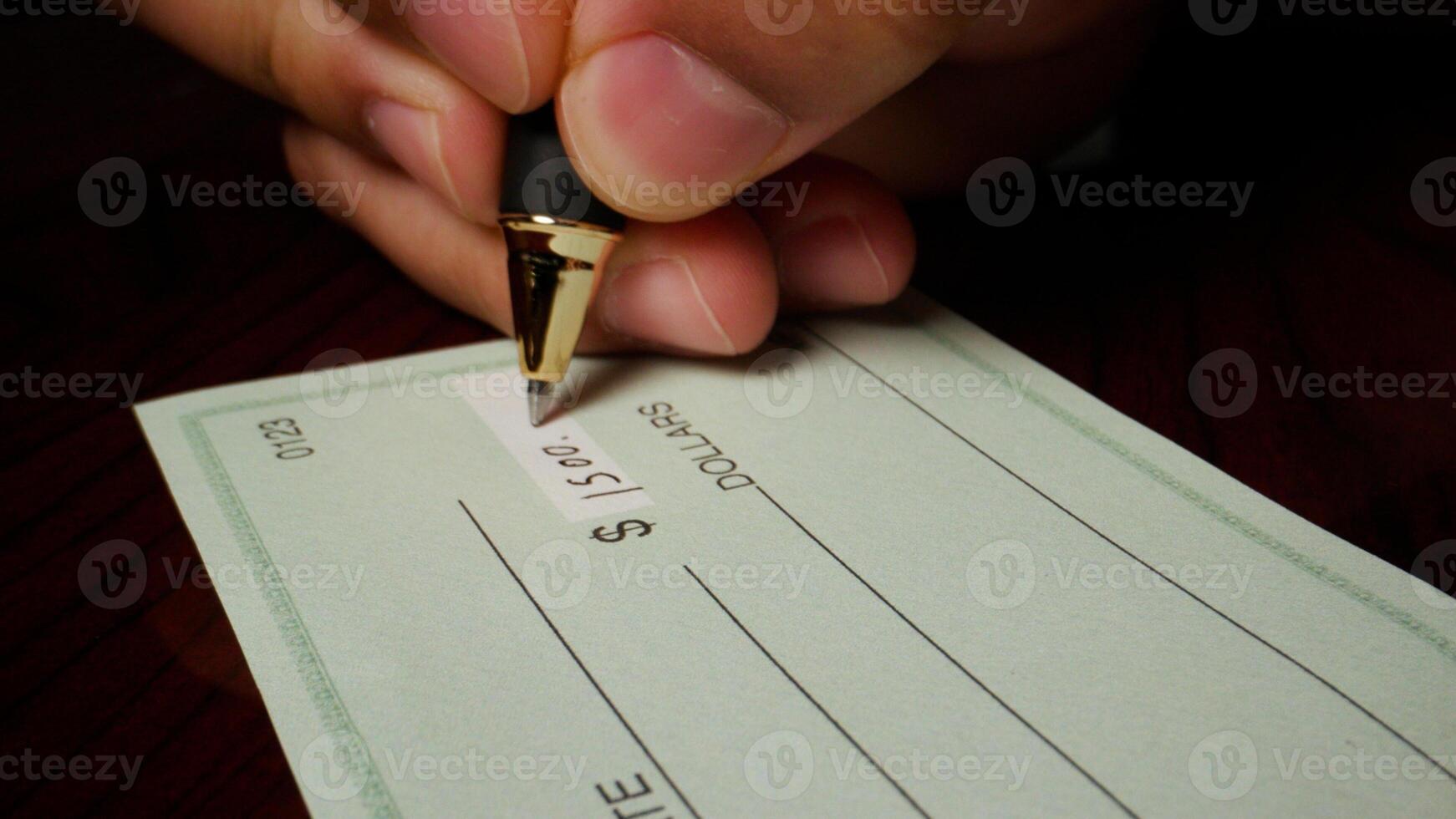 1 photo hispanic male hand filling out writing blank check
