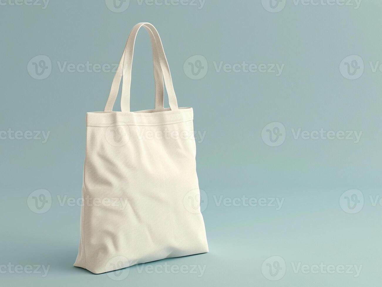 Eco friendly white cotton shopping bag. Isolated on a soft blue solid background. Studio shooting, mockup photo