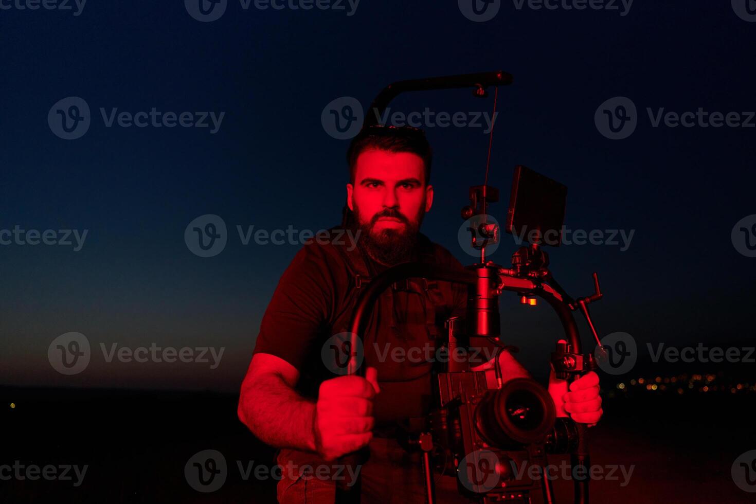 Nighttime Capture. Professional Videographer Films Athletes Running in Red-Lit Darkness photo