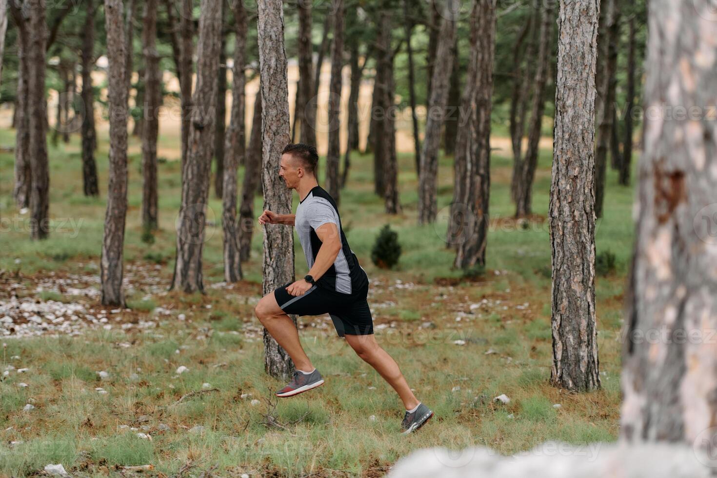 Determined Man Conquering Forest Obstacles with Grit and Speed photo