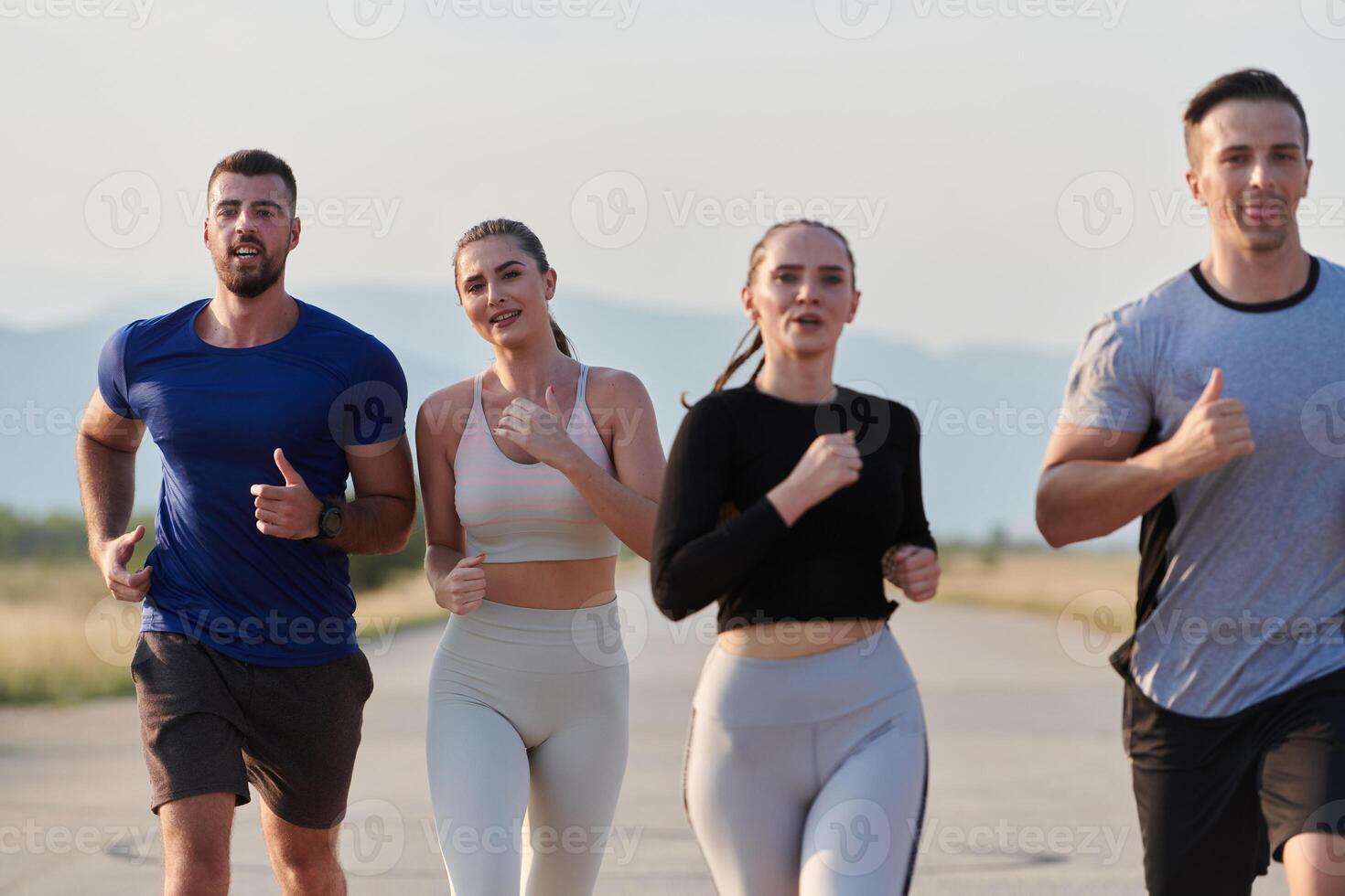 A group of friends maintains a healthy lifestyle by running outdoors on a sunny day, bonding over fitness and enjoying the energizing effects of exercise and nature photo
