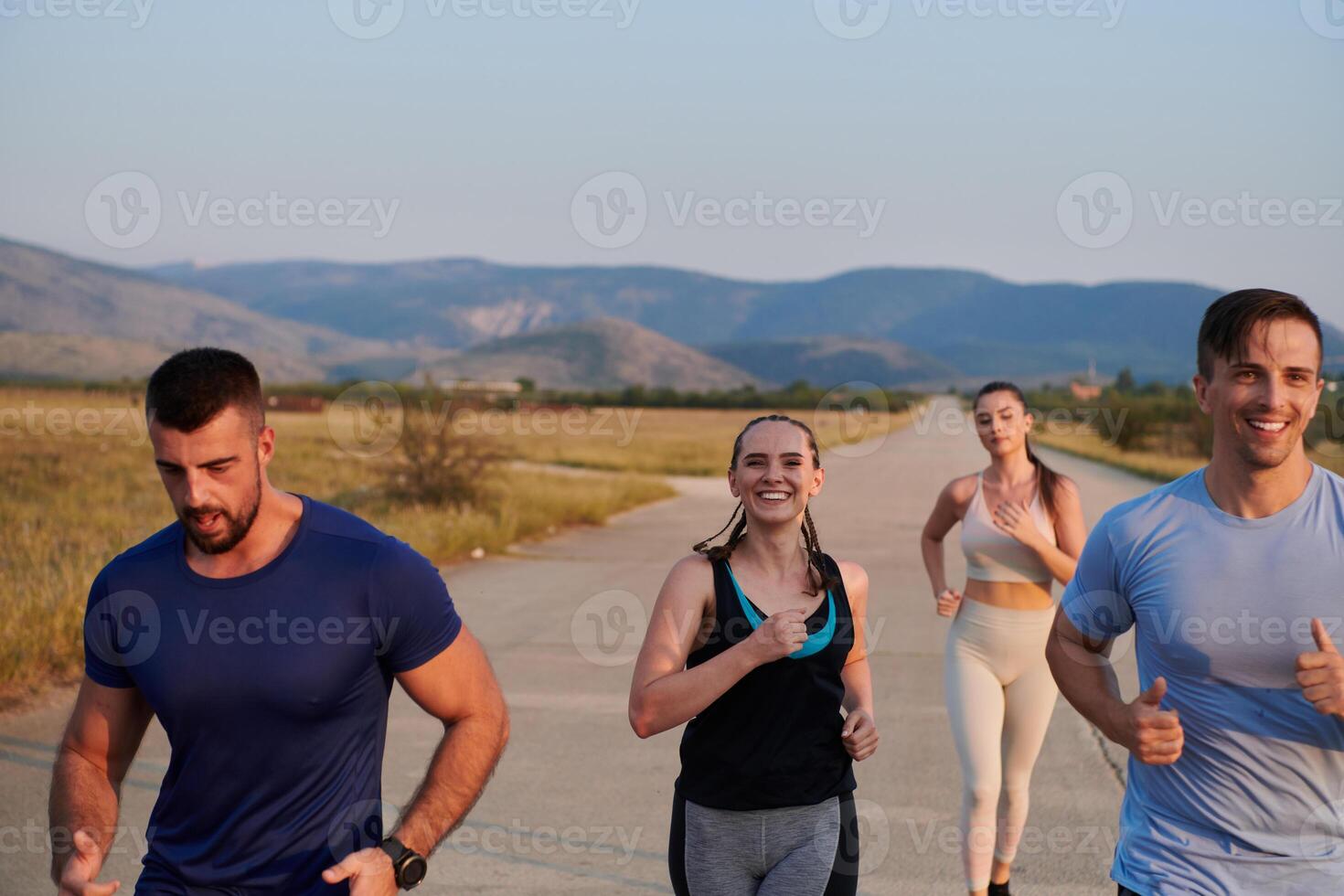 A group of friends maintains a healthy lifestyle by running outdoors on a sunny day, bonding over fitness and enjoying the energizing effects of exercise and nature photo