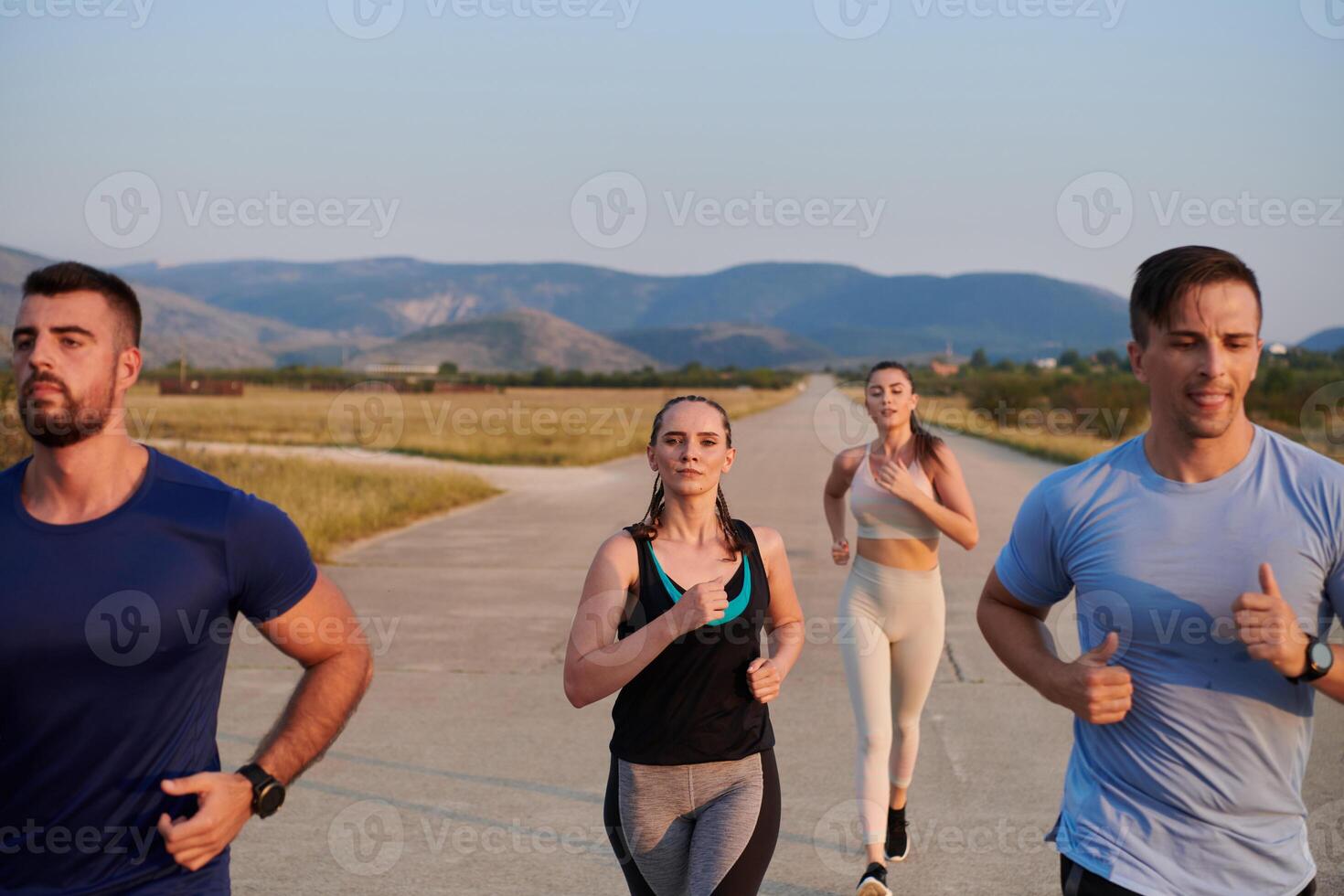 A group of friends maintains a healthy lifestyle by running outdoors on a sunny day, bonding over fitness and enjoying the energizing effects of exercise and nature photo