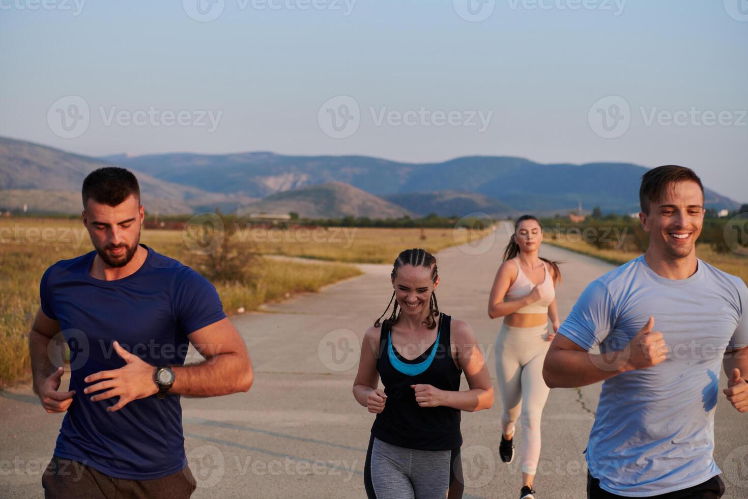 A group of friends maintains a healthy lifestyle by running outdoors on a sunny day, bonding over fitness and enjoying the energizing effects of exercise and nature photo