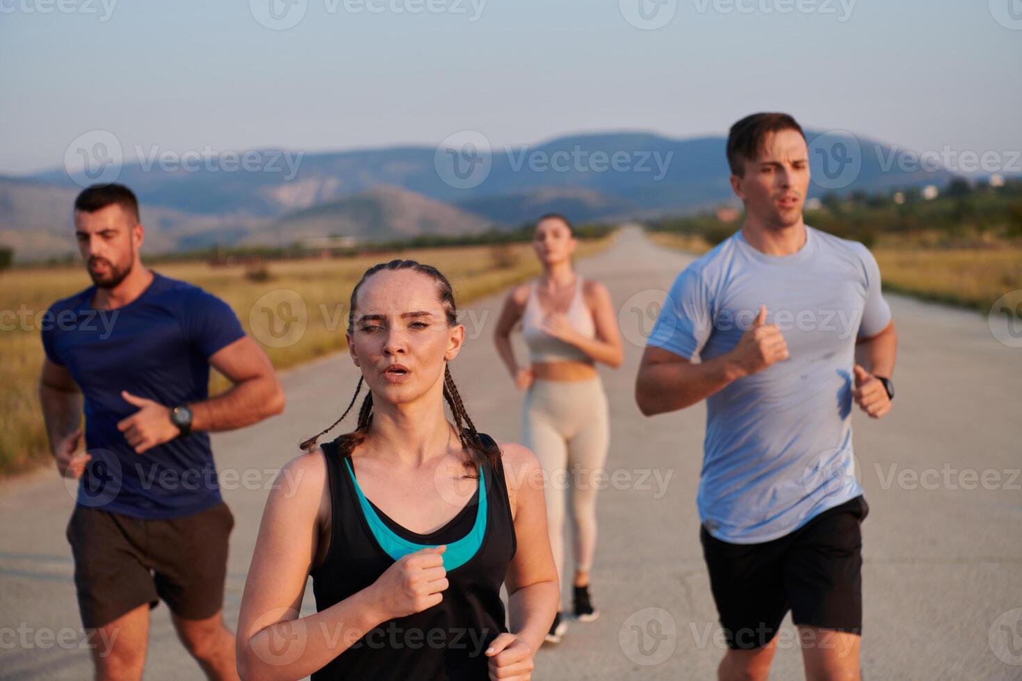 A group of friends maintains a healthy lifestyle by running outdoors on a sunny day, bonding over fitness and enjoying the energizing effects of exercise and nature photo