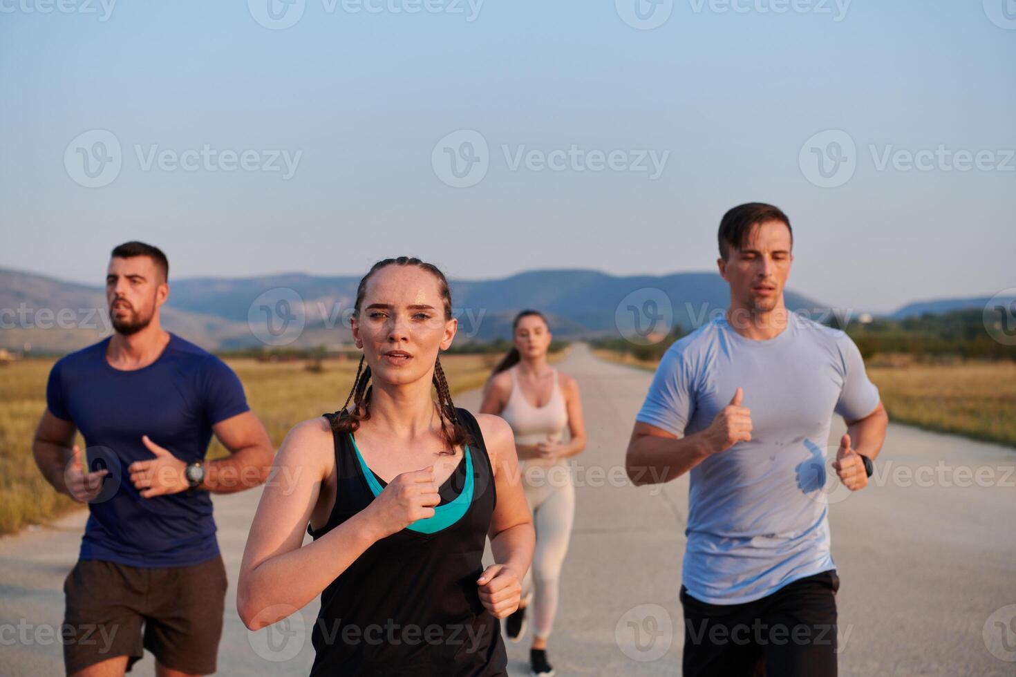 A group of friends maintains a healthy lifestyle by running outdoors on a sunny day, bonding over fitness and enjoying the energizing effects of exercise and nature photo