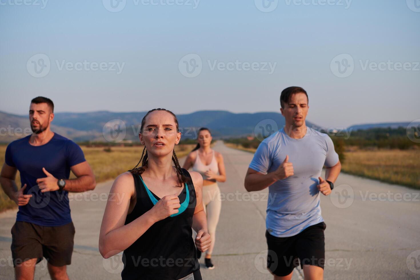 A group of friends maintains a healthy lifestyle by running outdoors on a sunny day, bonding over fitness and enjoying the energizing effects of exercise and nature photo