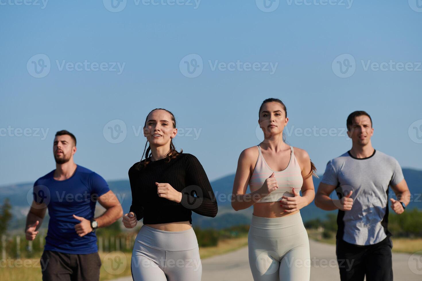 A group of friends maintains a healthy lifestyle by running outdoors on a sunny day, bonding over fitness and enjoying the energizing effects of exercise and nature photo