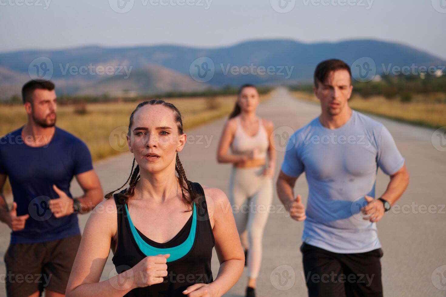A group of friends maintains a healthy lifestyle by running outdoors on a sunny day, bonding over fitness and enjoying the energizing effects of exercise and nature photo