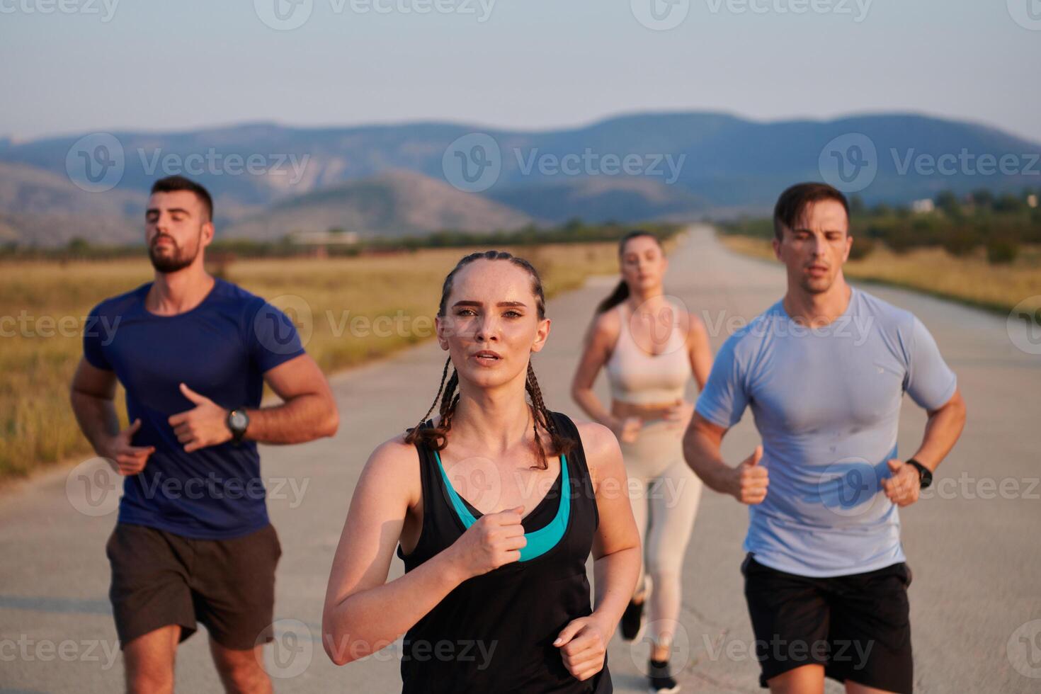 A group of friends maintains a healthy lifestyle by running outdoors on a sunny day, bonding over fitness and enjoying the energizing effects of exercise and nature photo
