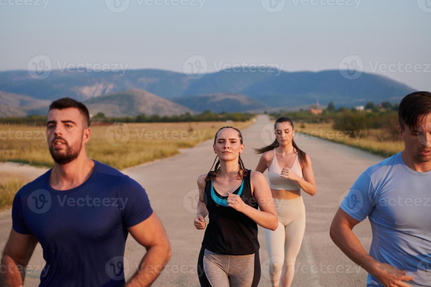 A group of friends maintains a healthy lifestyle by running outdoors on a sunny day, bonding over fitness and enjoying the energizing effects of exercise and nature photo
