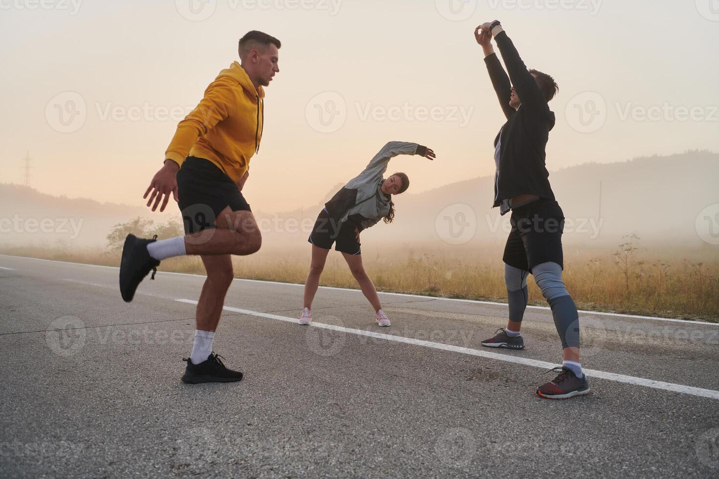 Diverse Athletes Prepare. Dynamic Group Warms Up for Morning Run. photo