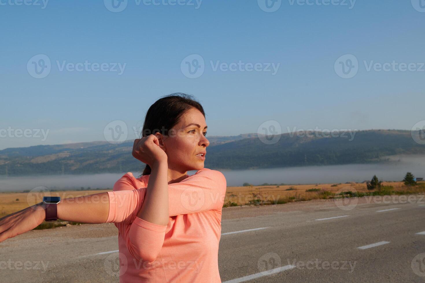 Determined Stretch. Athletic Woman Embraces Post-Run Flexibility in Nature. photo