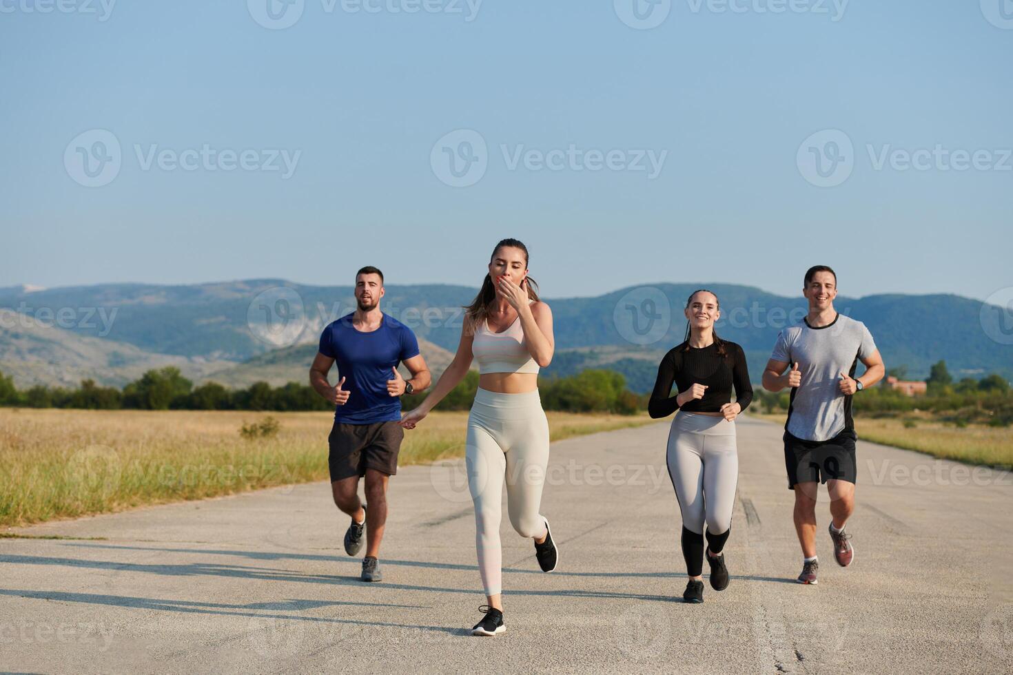 A group of friends maintains a healthy lifestyle by running outdoors on a sunny day, bonding over fitness and enjoying the energizing effects of exercise and nature photo