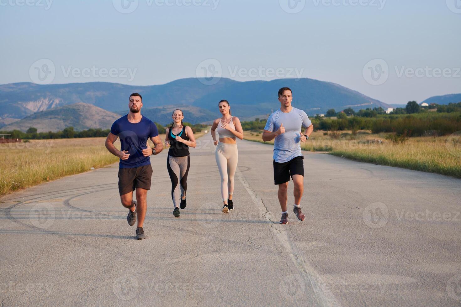 A group of friends maintains a healthy lifestyle by running outdoors on a sunny day, bonding over fitness and enjoying the energizing effects of exercise and nature photo