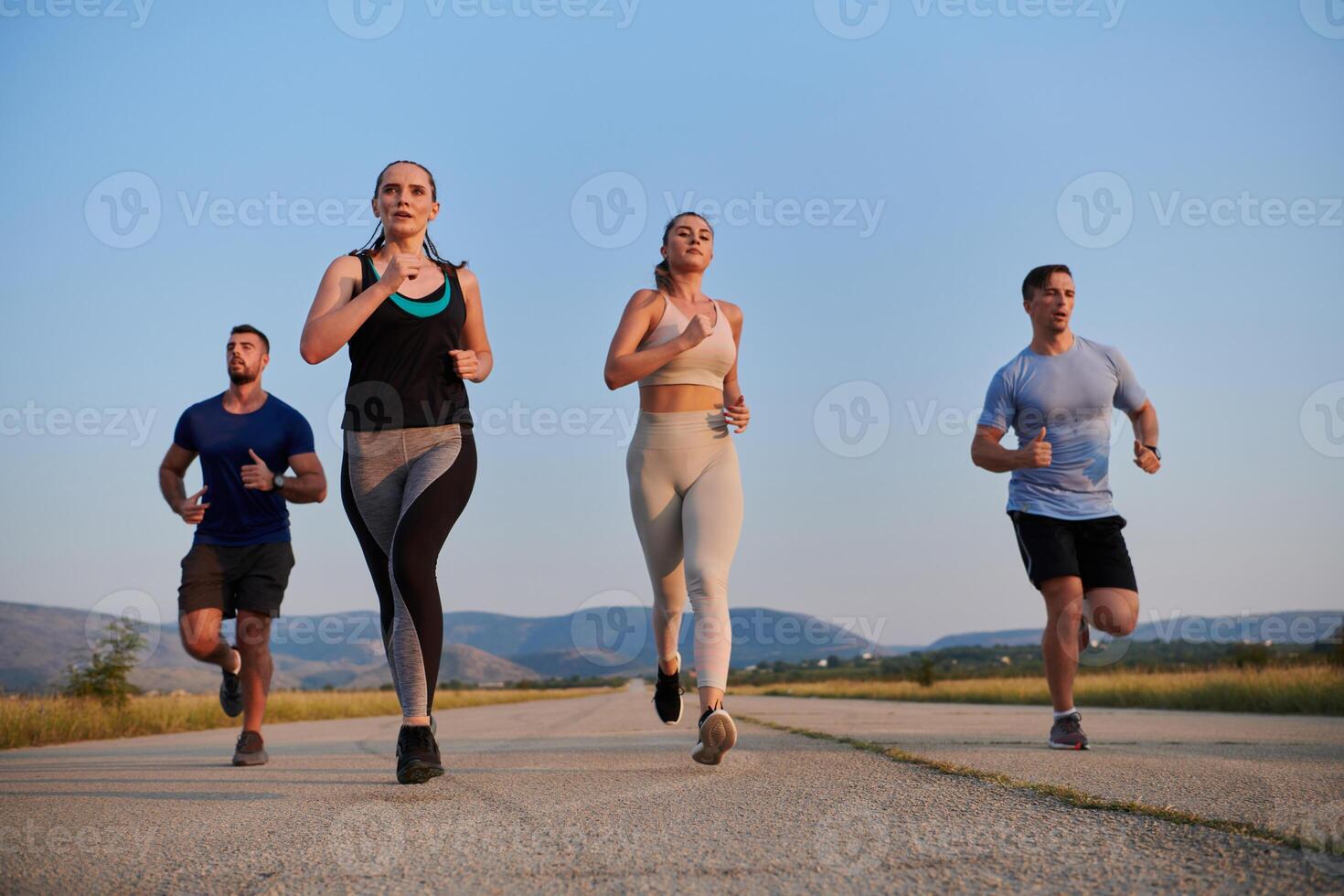 A group of friends maintains a healthy lifestyle by running outdoors on a sunny day, bonding over fitness and enjoying the energizing effects of exercise and nature photo