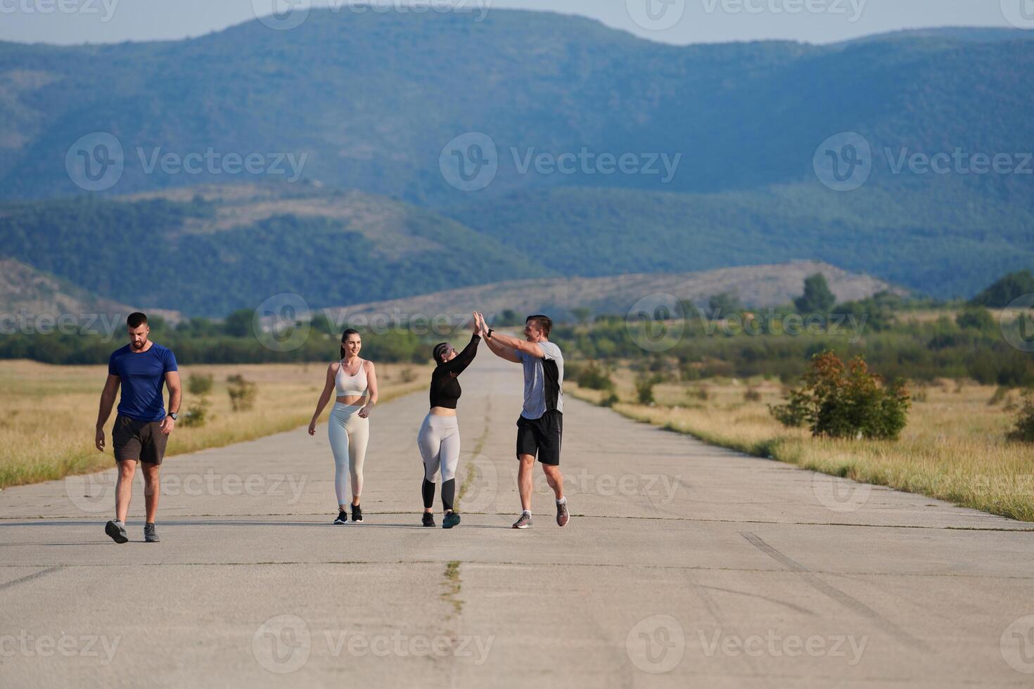 A group of friends maintains a healthy lifestyle by running outdoors on a sunny day, bonding over fitness and enjoying the energizing effects of exercise and nature photo